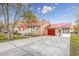Charming brick home featuring a bright red metal roof, garage, and a screened in porch at 602 Luttie Rd., Myrtle Beach, SC 29588