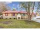 Charming brick home featuring a bright red metal roof and red shutters at 602 Luttie Rd., Myrtle Beach, SC 29588