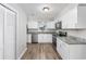 Bright kitchen with white cabinets, stainless steel appliances, granite countertops, and vinyl plank flooring at 602 Luttie Rd., Myrtle Beach, SC 29588