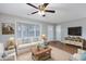 Bright living room with a ceiling fan, a bay window and staged furniture at 602 Luttie Rd., Myrtle Beach, SC 29588