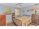 Well-lit bedroom with a colorful quilt, hardwood floors, and a vintage-style dresser at 609 Hillside Dr. S. # E-18, North Myrtle Beach, SC 29582