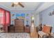 Comfortable bedroom with hardwood floors, stylish furniture, and a view of the outdoors at 609 Hillside Dr. S. # E-18, North Myrtle Beach, SC 29582