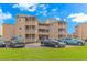 A charming tan condo building with parking and green space at 609 Hillside Dr. S. # E-18, North Myrtle Beach, SC 29582