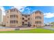 Waipani building exterior showcasing its unique architecture and beautiful landscaping with parking and golf cart at 609 Hillside Dr. S. # E-18, North Myrtle Beach, SC 29582