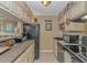 Compact kitchen featuring black appliances, granite countertops, and beach-themed decor for a coastal vibe at 609 Hillside Dr. S. # E-18, North Myrtle Beach, SC 29582