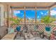 Screened patio with wicker furniture, plants, and coastal decor overlooking neighborhood at 609 Hillside Dr. S. # E-18, North Myrtle Beach, SC 29582