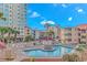 Community pool with ample seating, cabana, and views of the surrounding buildings at 609 Hillside Dr. S. # E-18, North Myrtle Beach, SC 29582