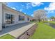 A covered patio with sliding glass doors leads to an outdoor seating area and well-maintained lawn by the waterway at 619 Crestview Ct., Longs, SC 29568