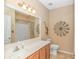 Bathroom featuring large mirror, single sink vanity, and neutral walls and decor at 619 Crestview Ct., Longs, SC 29568