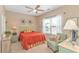 Bright bedroom with a ceiling fan, a bedside lamp, a large window, and an comfortable chair at 619 Crestview Ct., Longs, SC 29568