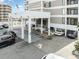 Well-maintained building entrance with covered parking, palm trees and ocean views at 6200 N Ocean Blvd. # 501, North Myrtle Beach, SC 29582