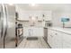 Modern white kitchen featuring stainless steel appliances and quartz countertops at 6200 N Ocean Blvd. # 501, North Myrtle Beach, SC 29582