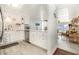 Bright, all-white kitchen with stainless steel appliances and a seamless flow to the dining area at 6200 N Ocean Blvd. # 501, North Myrtle Beach, SC 29582
