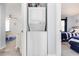 Hallway view of a stacked white washer and dryer set at 6200 N Ocean Blvd. # 501, North Myrtle Beach, SC 29582