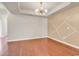 Open dining room with hardwood floors, a modern chandelier, and a decorative accent wall at 675 Pistoia Ln. # 675, Myrtle Beach, SC 29579