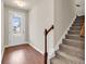 Welcoming entryway with hardwood floors, staircase, and glass door allowing natural light at 675 Pistoia Ln. # 675, Myrtle Beach, SC 29579