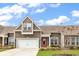 Charming home featuring brown shingles, a white garage door, and a vibrant red front door at 675 Pistoia Ln. # 675, Myrtle Beach, SC 29579