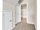 Hallway featuring access to bathroom with white doors, neutral carpet, and white trim at 675 Pistoia Ln. # 675, Myrtle Beach, SC 29579