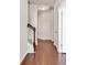 Hallway with hardwood floors, white trim, and a staircase leading to the upper level at 675 Pistoia Ln. # 675, Myrtle Beach, SC 29579