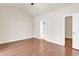 Spacious main bedroom featuring hardwood floors, vaulted ceilings, and ensuite bathroom entrance at 675 Pistoia Ln. # 675, Myrtle Beach, SC 29579