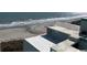 Oceanfront view of waves breaking on a sandy beach from atop of the Monterey Bay Suites in Myrtle Beach at 6804 N Ocean Blvd. # 1237, Myrtle Beach, SC 29572