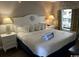 Well-lit bedroom featuring a white seashell headboard and bright bedside lamps at 6804 N Ocean Blvd. # 1237, Myrtle Beach, SC 29572