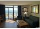 Living room with ocean view, balcony, and living room furniture at 6804 N Ocean Blvd. # 1237, Myrtle Beach, SC 29572