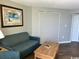 Cozy living room with couch, murphy bed, and beach themed art at 6804 N Ocean Blvd. # 1237, Myrtle Beach, SC 29572