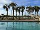 Beautiful pool area surrounded by palm trees, lounge chairs, and a sunny sky at 6804 N Ocean Blvd. # 1237, Myrtle Beach, SC 29572