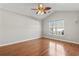 Spacious bedroom with a vaulted ceiling, hardwood floors, and a bright window at 7377 Guinevere Circle, Myrtle Beach, SC 29588