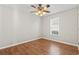 Empty bedroom featuring a ceiling fan, hardwood floors and a window at 7377 Guinevere Circle, Myrtle Beach, SC 29588