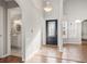 Open and bright foyer features archways, a view of the staircase, tile flooring, and a modern light fixture at 7377 Guinevere Circle, Myrtle Beach, SC 29588