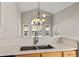 Bright kitchen featuring white quartz countertops, a stainless steel sink and a view of the backyard at 7377 Guinevere Circle, Myrtle Beach, SC 29588