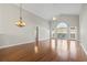 Open-concept living room with vaulted ceilings and gleaming hardwood floors, bathed in natural light at 7377 Guinevere Circle, Myrtle Beach, SC 29588