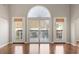 Living area with a sliding glass door leading outside and a large arched window above at 7377 Guinevere Circle, Myrtle Beach, SC 29588