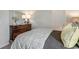 Cozy bedroom features a dark wooden dresser with a mirror, a patterned bedspread, and neutral walls at 900 Agostino Dr., Myrtle Beach, SC 29579