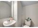 Neat powder room featuring a white sink, toilet, neutral walls, and a large mirror to brighten the space at 900 Agostino Dr., Myrtle Beach, SC 29579