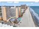 Expansive aerial view of a beachfront resort with multiple pools, a tiki bar, and ocean views at 9550 Shore Dr. # 1511, Myrtle Beach, SC 29572