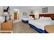 Bedroom includes two beds, wood floors, dresser, lamps, and TV at 9550 Shore Dr. # 1511, Myrtle Beach, SC 29572