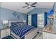 Comfortable blue bedroom with decorative accents, a ceiling fan, and a window view at 1006 Charles St., North Myrtle Beach, SC 29582