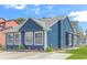 Charming blue home featuring a well-maintained yard and beautiful landscaping at 1006 Charles St., North Myrtle Beach, SC 29582