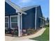 Beautiful blue home highlighting manicured landscaping and a sidewalk at 1006 Charles St., North Myrtle Beach, SC 29582
