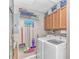 Functional laundry room equipped with a washer, dryer, and ample storage shelving at 1006 Charles St., North Myrtle Beach, SC 29582