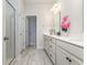 Stylish bathroom with double sinks, white cabinetry and a glass-enclosed shower at 10141 Hamilton Branch Loop, Myrtle Beach, SC 29579
