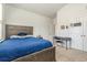 Cozy bedroom featuring a wooden bed frame and a workspace with a desk and chair at 10141 Hamilton Branch Loop, Myrtle Beach, SC 29579