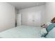 Bright bedroom featuring a bed with decorative pillows, a double door closet, and an open doorway at 10141 Hamilton Branch Loop, Myrtle Beach, SC 29579