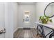 Modern entryway with light gray wood floors, a stylish console table, and natural light from the front door at 10141 Hamilton Branch Loop, Myrtle Beach, SC 29579