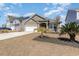 Charming single-story home with a well-manicured lawn, attached garage, and covered porch at 10141 Hamilton Branch Loop, Myrtle Beach, SC 29579
