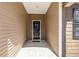 A welcoming covered porch with brick flooring leads to the front door at 10141 Hamilton Branch Loop, Myrtle Beach, SC 29579