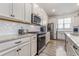 Modern kitchen featuring stainless steel appliances, granite countertops, and white cabinetry at 10141 Hamilton Branch Loop, Myrtle Beach, SC 29579